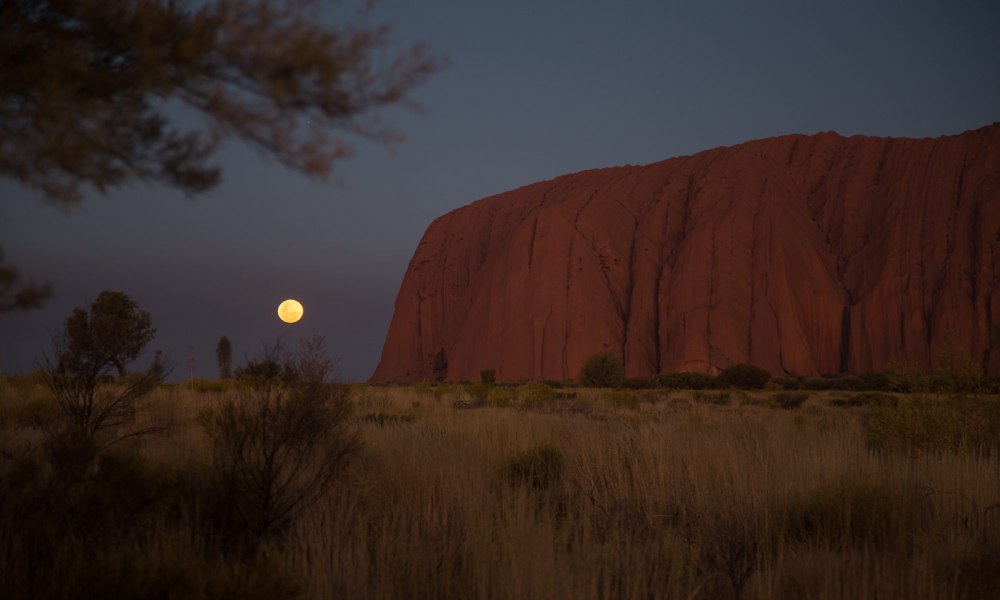 Image of the moon rising over Uluru